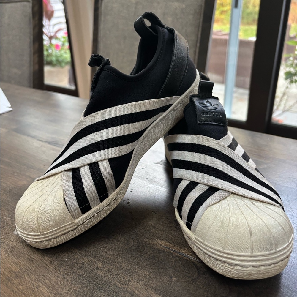 Adidas Black and White Slip-Ons
Size 7.5-runs big. I wear 8 and these are roomy.